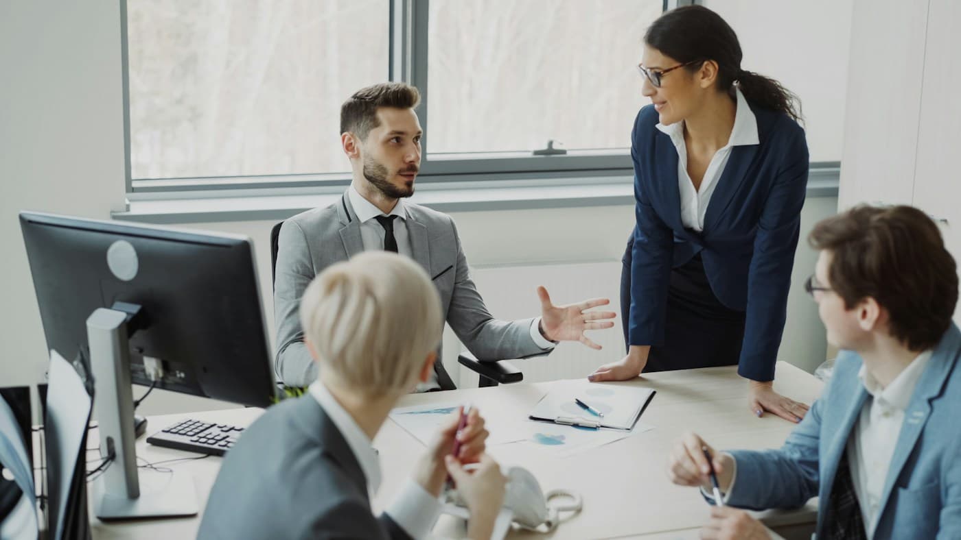 Professionals in conversation around a meeting table