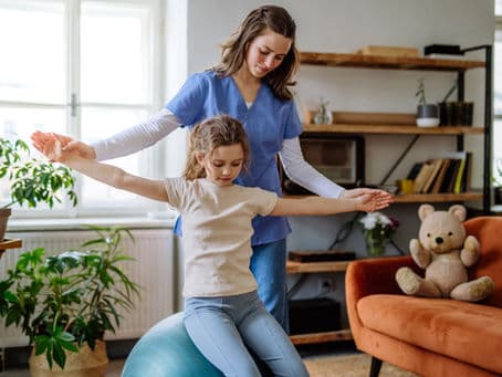 A therapist working with a young patient, illustrating the growing importance of occupational therapy.